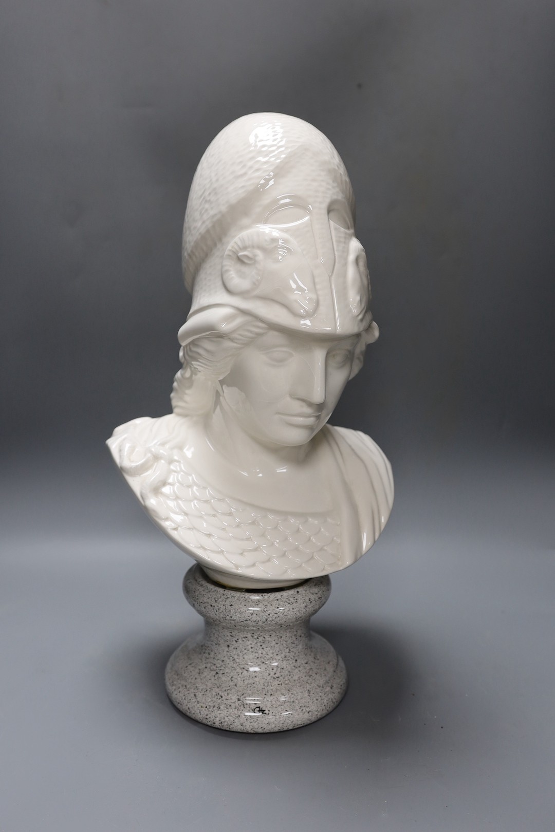 A white glazed ceramic portrait bust of Athena on faux marble plinth 49cm